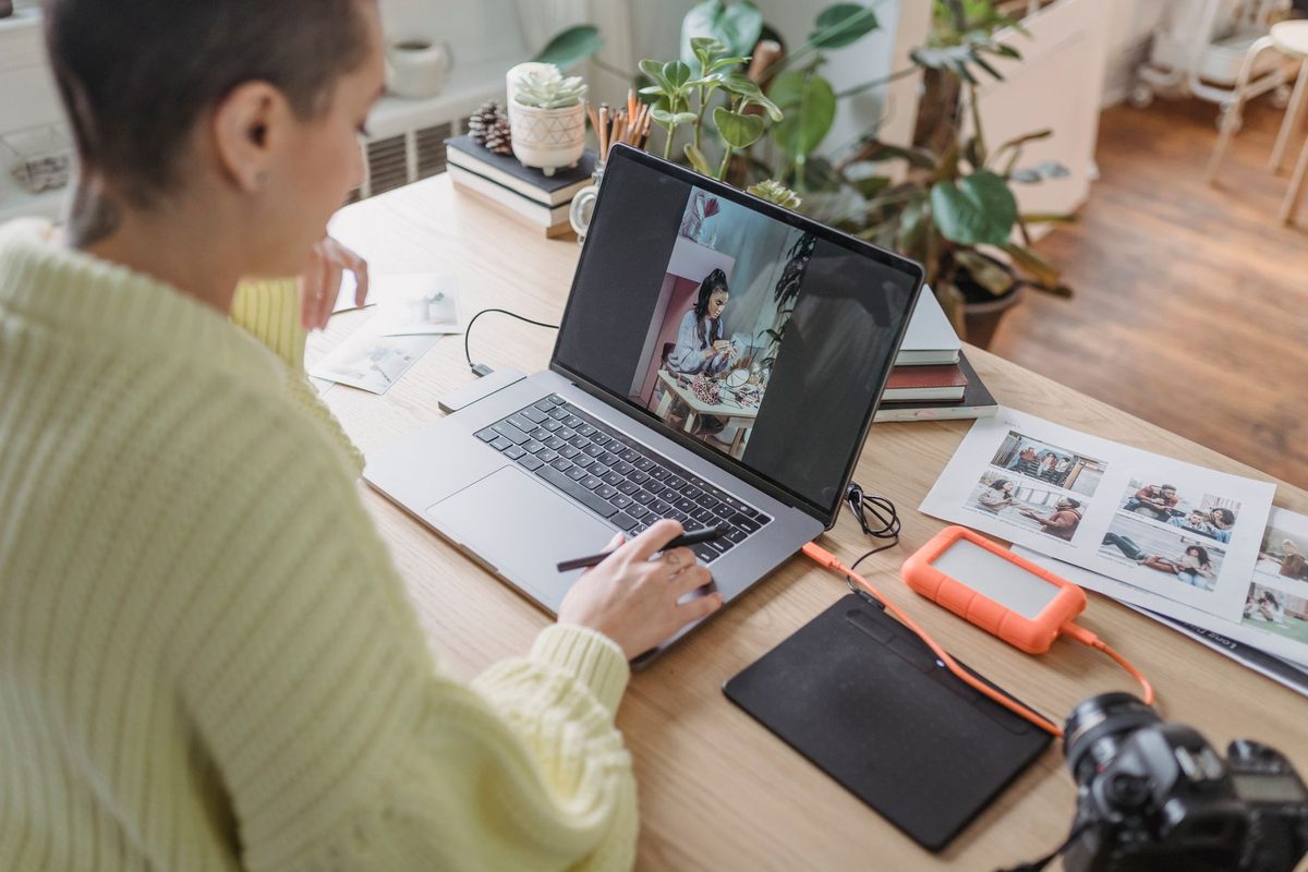 A photographer reviewing images on a laptop, relevant to free alternatives to Adobe Lightroom