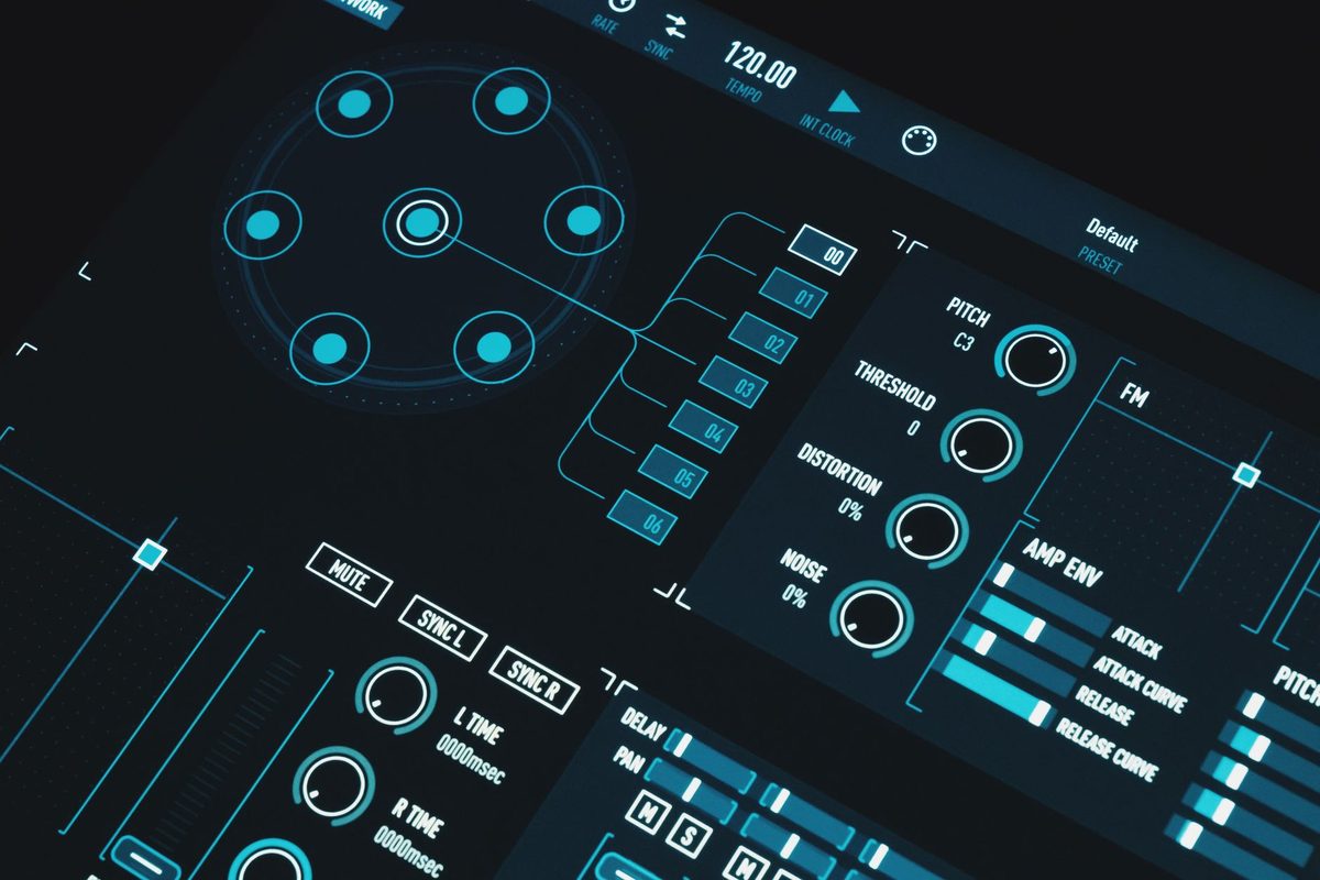 A UI designer laying out interface screens on a monitor, comparing free alternatives to Adobe XD