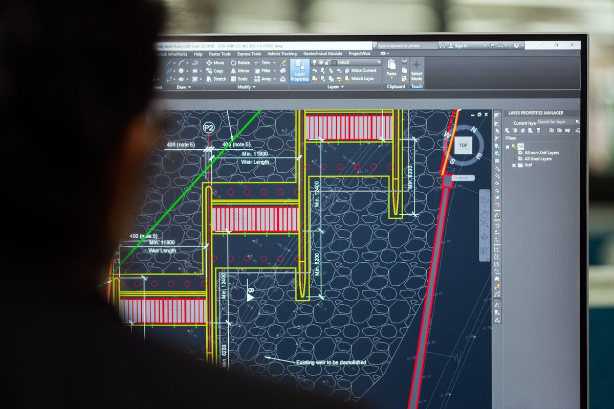 An engineer working on technical CAD drawings, relevant to free alternatives to AutoCAD