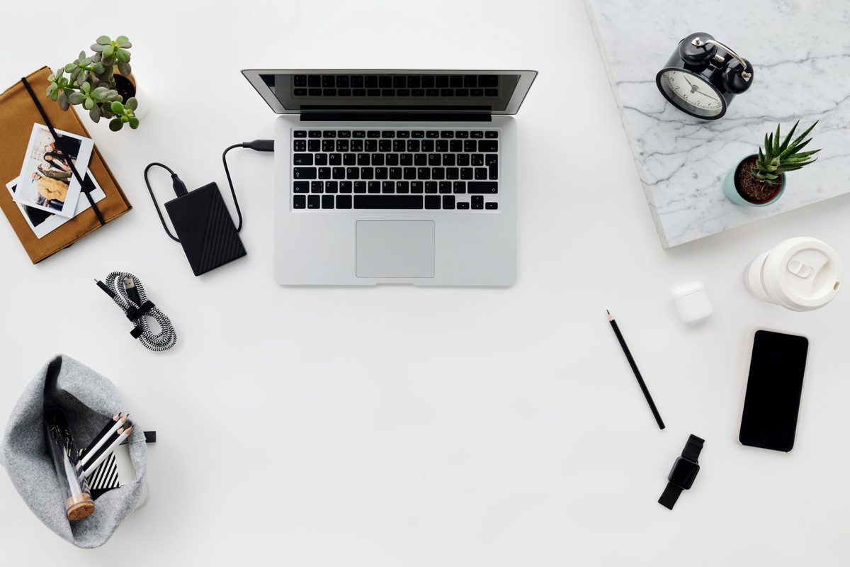 A laptop with an external drive for backups, relevant to free alternatives to Dropbox