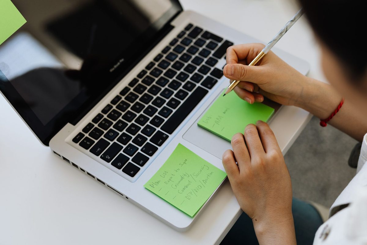 Working on notes and planning at a desk, relevant to free alternatives to Notion