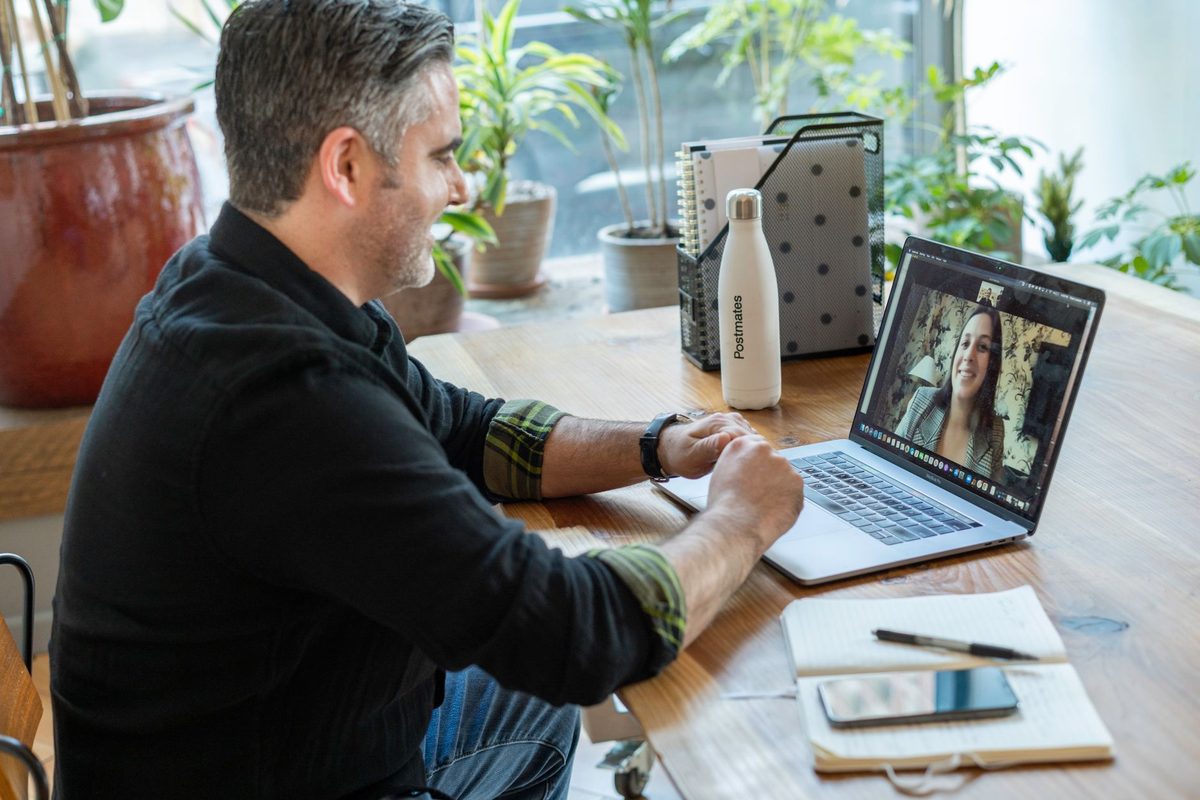 A person on a video call at a desk, relevant to free alternatives to Zoom