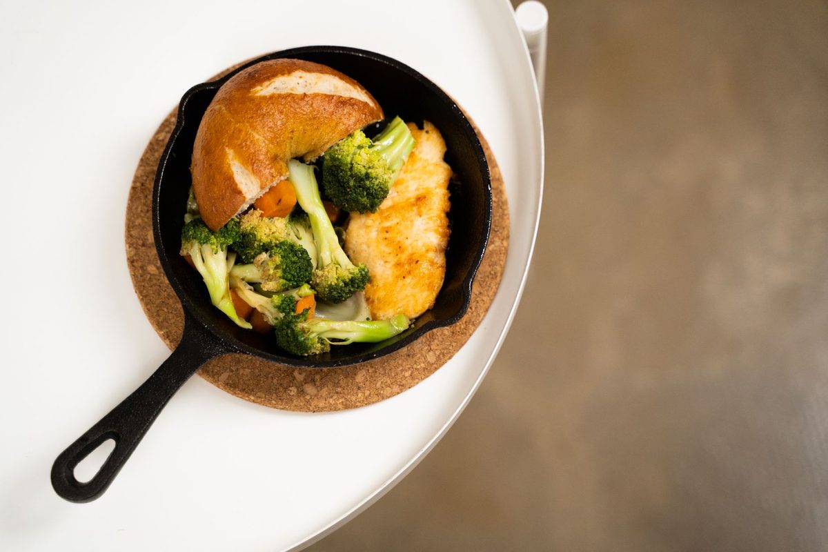 A black cast iron skillet on a wooden kitchen surface