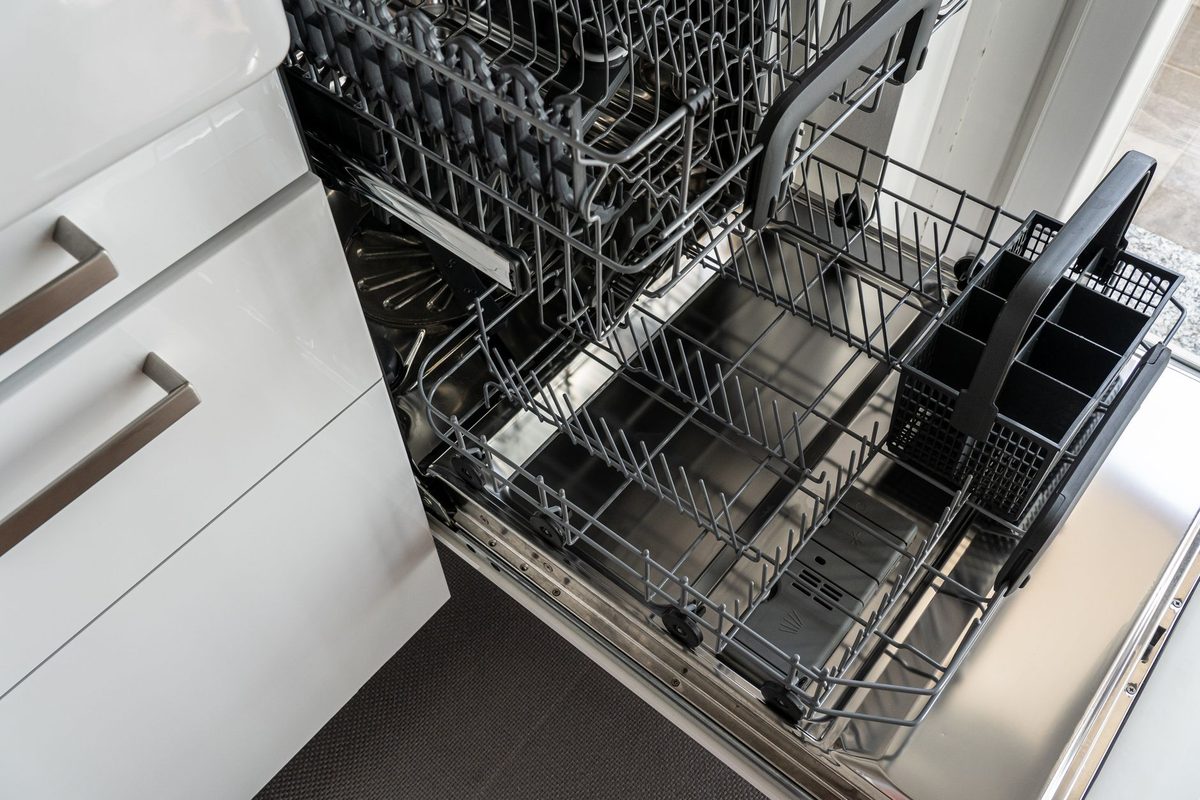 A clean dishwasher interior with racks visible, relevant to how to clean a dishwasher