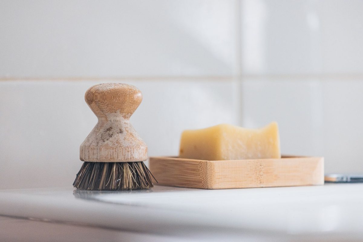 Scrubbing tile grout with a brush, relevant to how to clean grout