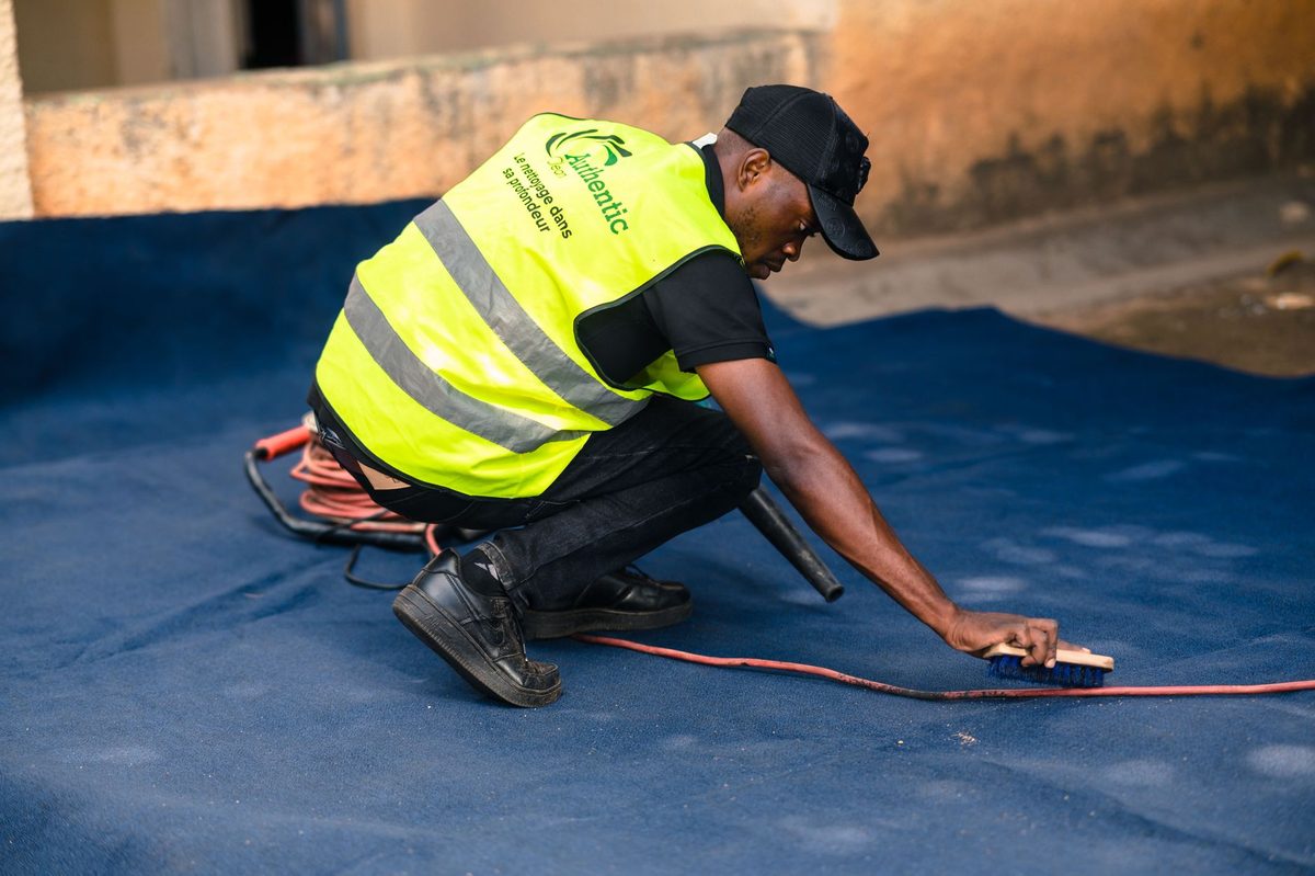 Blotting a carpet with a cloth, relevant to how to remove carpet stains